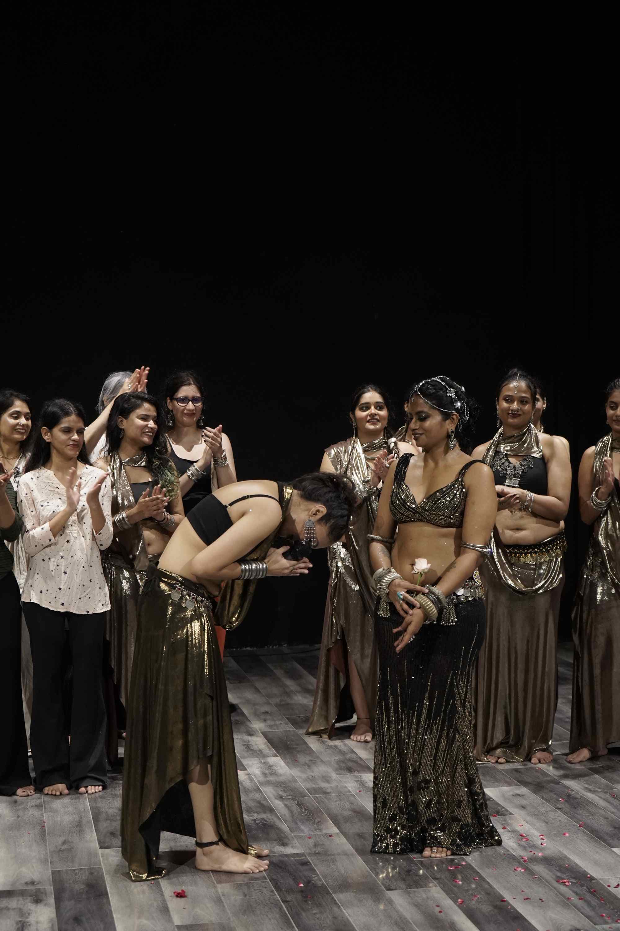 The dancer bowing to the applause, the company behind her
