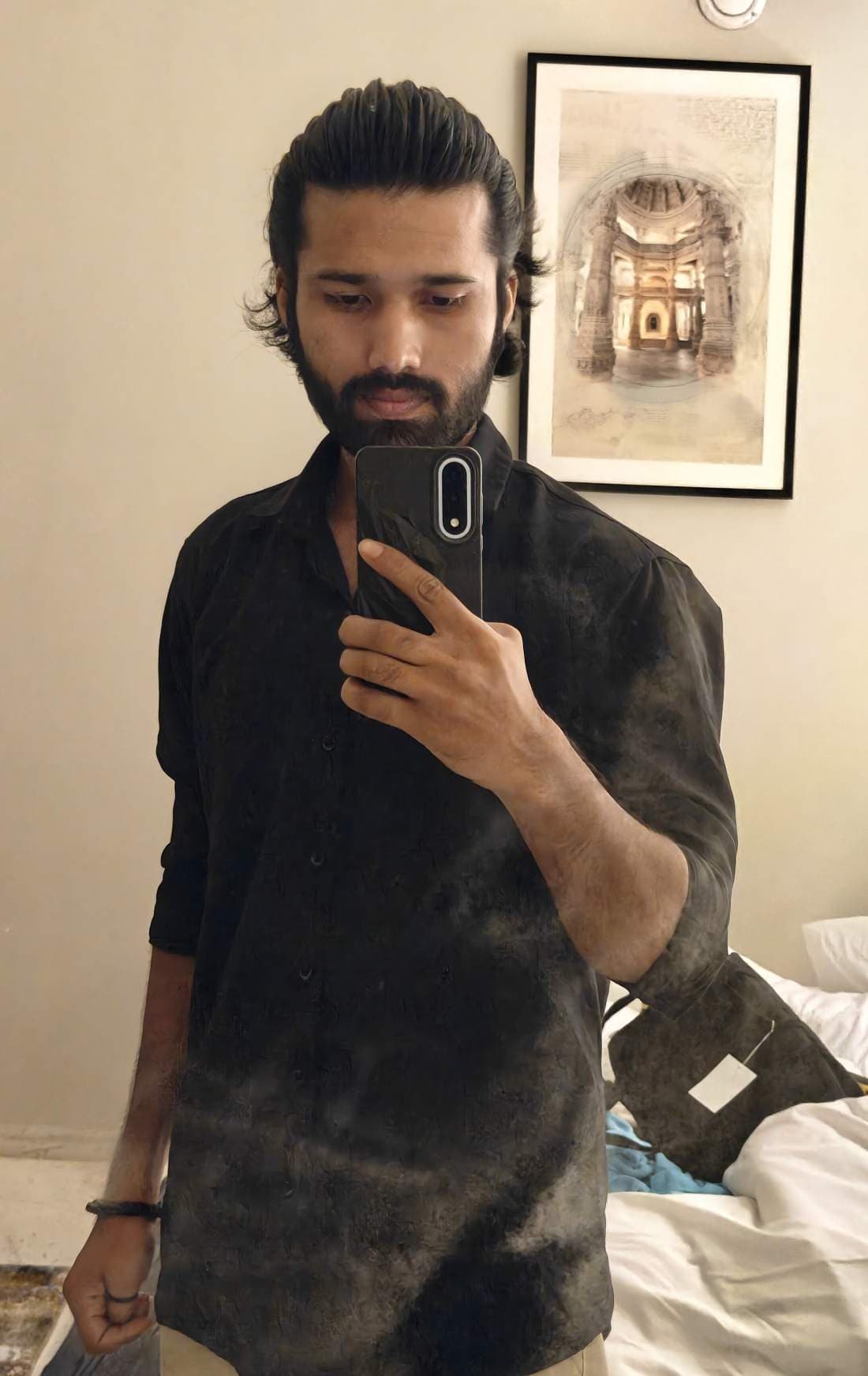 Balram Jaina in a mirror, phone raised
