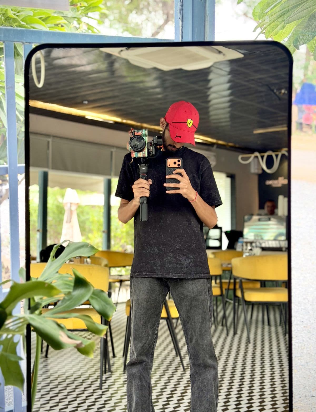 Nikhil Prajapat framing a mirror shot, camera on the gimbal beside him