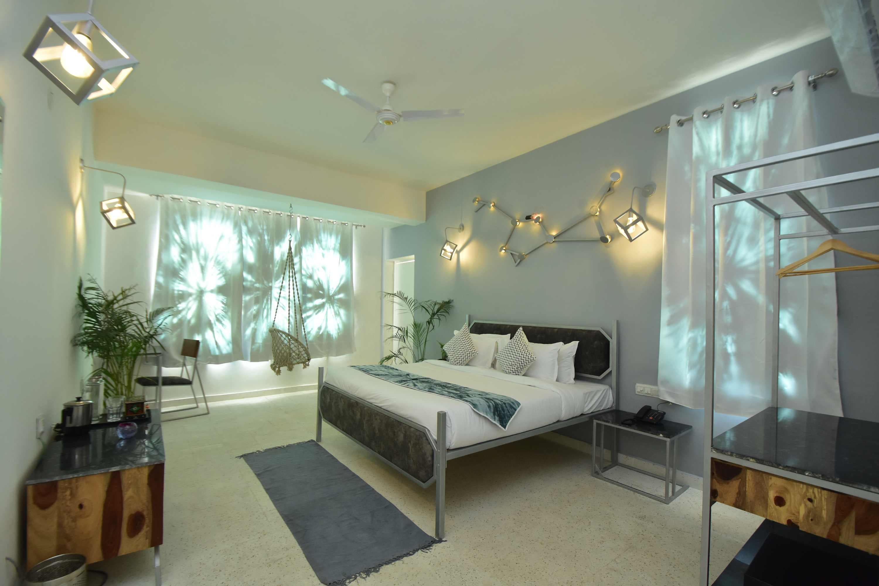 A bedroom interior strung with fairy lights