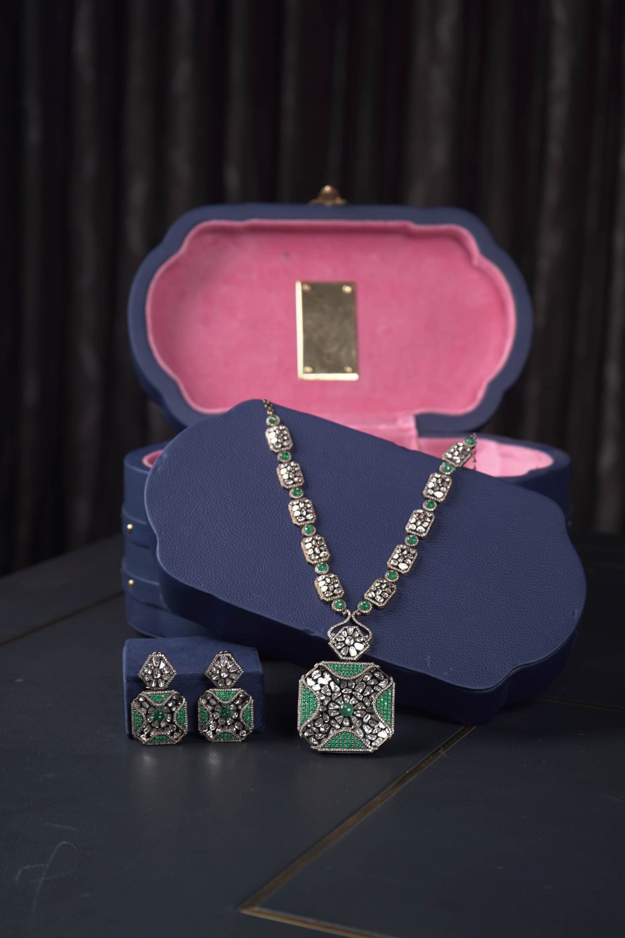 A polki necklace and earrings in their blue presentation box