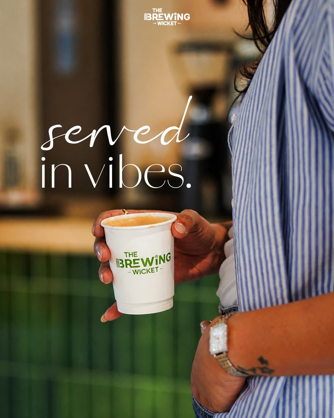 Campaign frame — “served in vibes”, the branded cup in hand