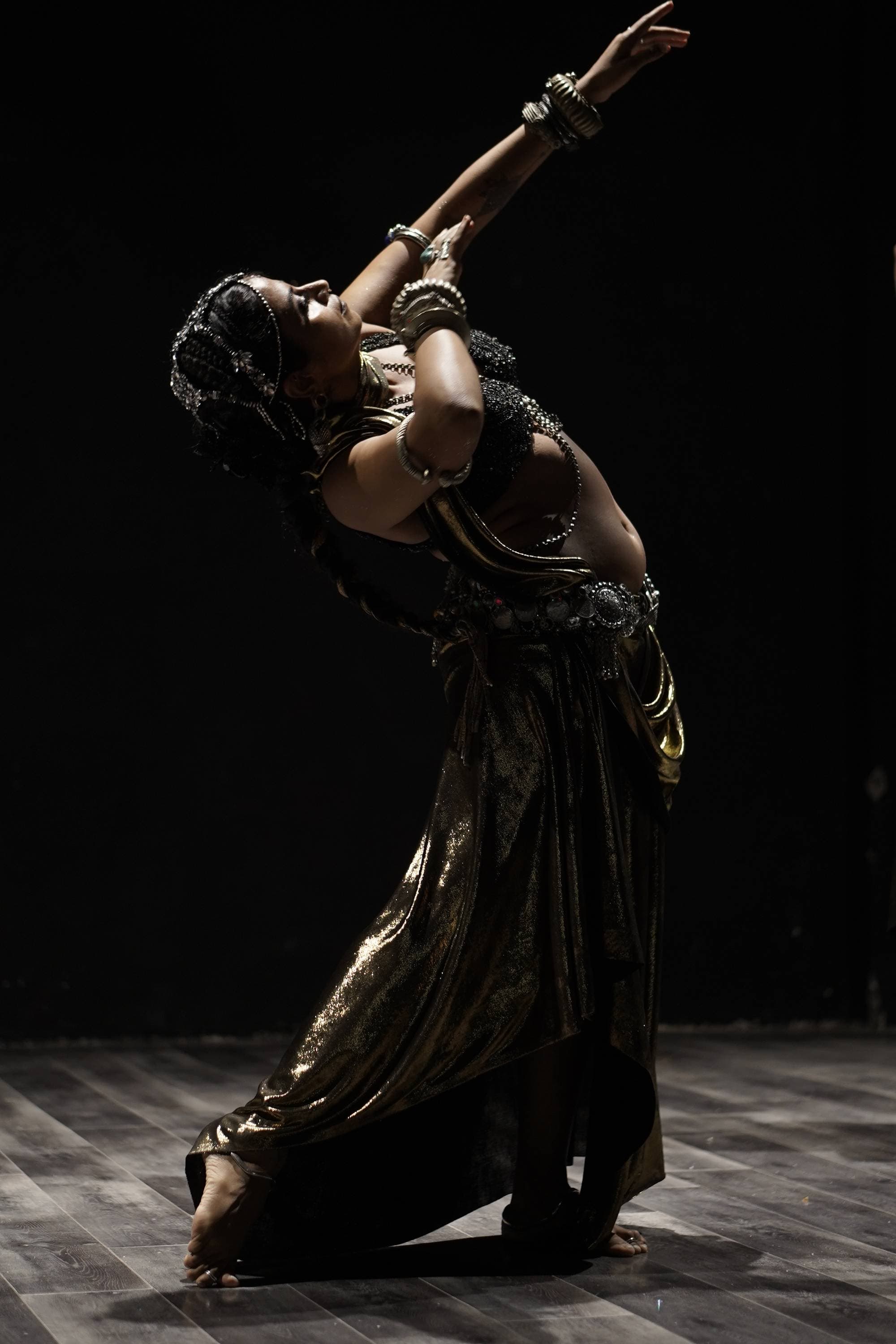 A dancer arched back under the stage light