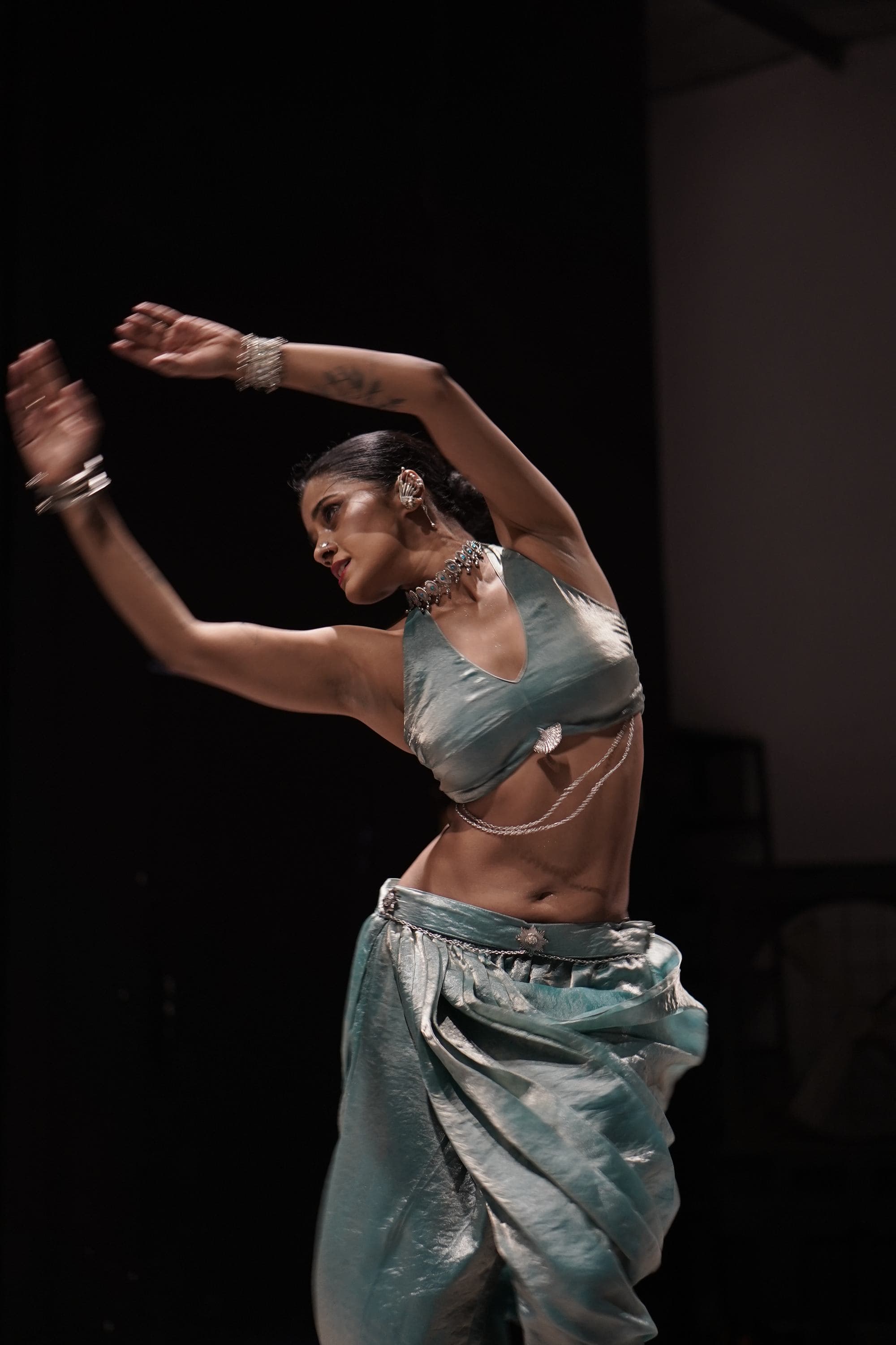 A dancer in blue caught mid-movement